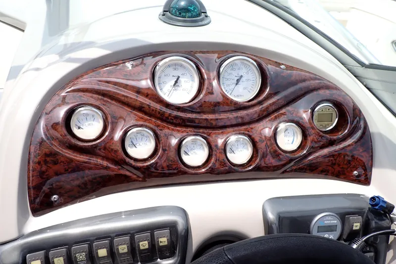 Slide: The Image of Dashboard of a 2005 Monterey 270 Cruiser with wood finish and multiple gauges. - 15