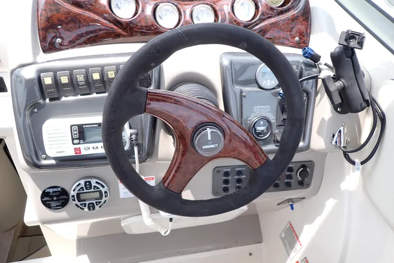 Slide: The Image of Steering wheel and dashboard of a 2005 Monterey 270 Cruiser boat. - 16