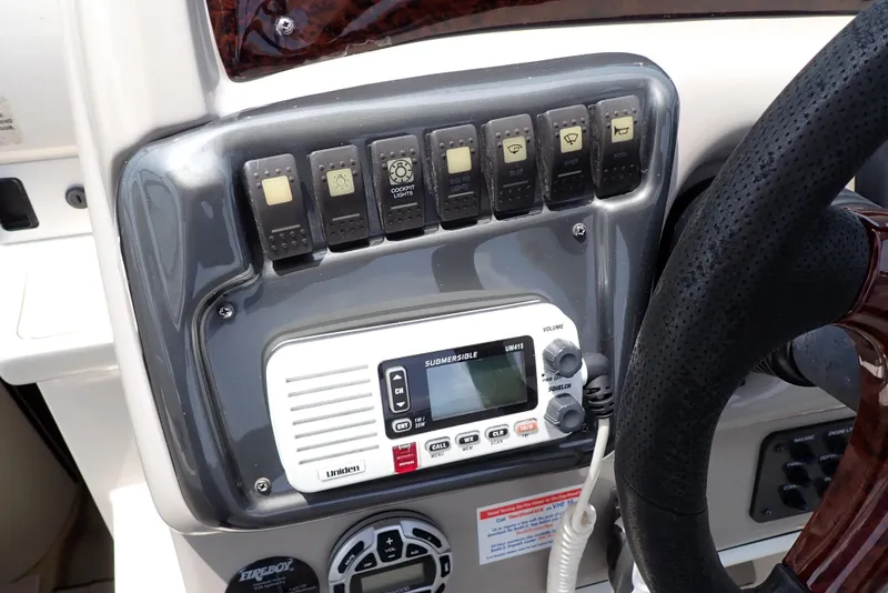 Slide: The Image of Control panel of a 2005 Monterey 270 Cruiser boat with switches and a radio. - 17