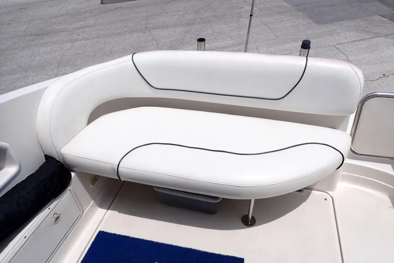 Slide: The Image of 2005 Monterey 270 Cruiser boat seat with white upholstery and black trim. - 22