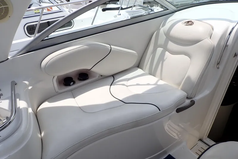 Slide: The Image of 2005 Monterey 270 Cruiser interior seating with white upholstery and cup holders. - 24