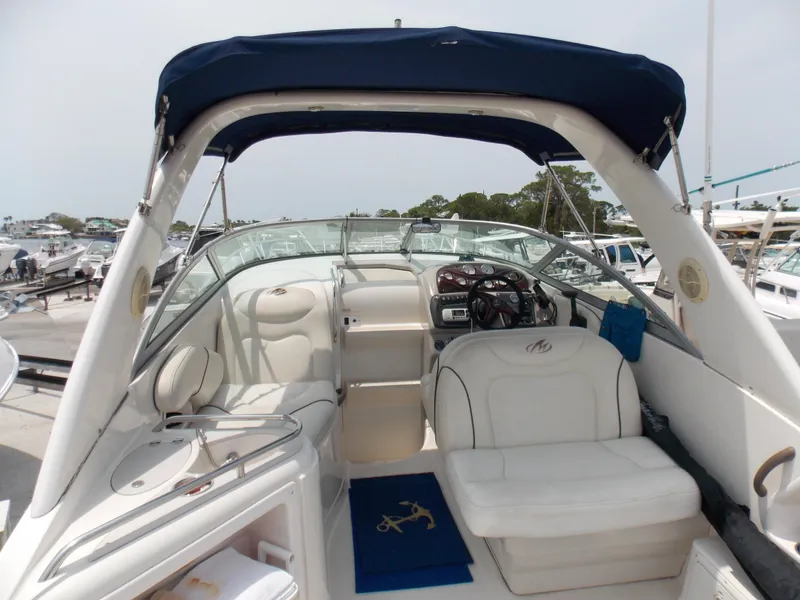 Slide: The Image of 2005 Monterey 270 Cruiser boat interior with white seating and blue canopy. - 4