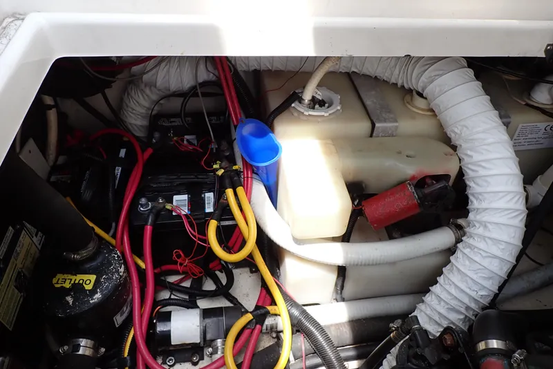 Slide: The Image of Engine compartment of a 2005 Monterey 270 Cruiser with visible wiring and components. - 49
