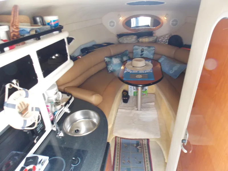 Slide: The Image of Interior of a 2005 Monterey 270 Cruiser with cozy seating and kitchenette. - 7