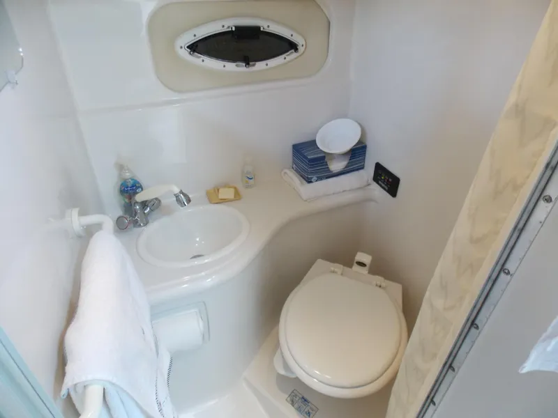 Slide: The Image of Compact bathroom in 2005 Monterey 270 Cruiser boat with sink, toilet, and porthole. - 9