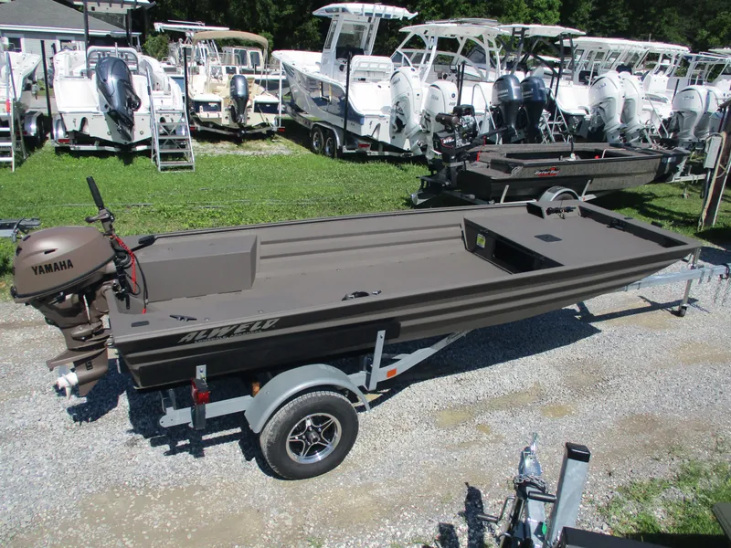 Slide: The Image of 2025 Alweld 1548 Marsh boat on trailer, surrounded by other boats in a dealership. - 0