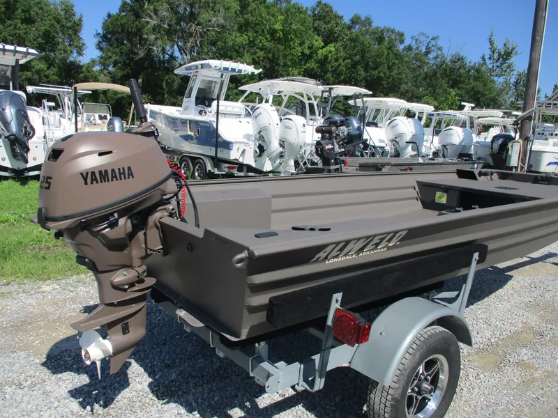 Slide: The Image of 2025 Alweld 1548 Marsh boat with Yamaha motor, parked on a trailer, surrounded by other boats. - 4