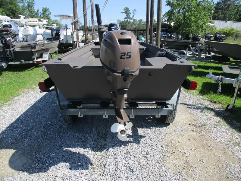 Slide: The Image of 2025 Alweld 1548 Marsh boat with outboard motor on a trailer, parked on gravel. - 5