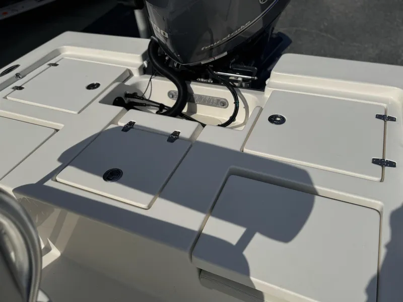 Slide: The Image of 2014 Pathfinder 2200 TRS boat deck with storage compartments and engine. - 12