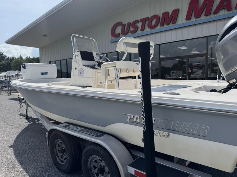 Slide: The Image of 2014 Pathfinder 2200 TRS boat on trailer outside Custom Marine dealership. - 3