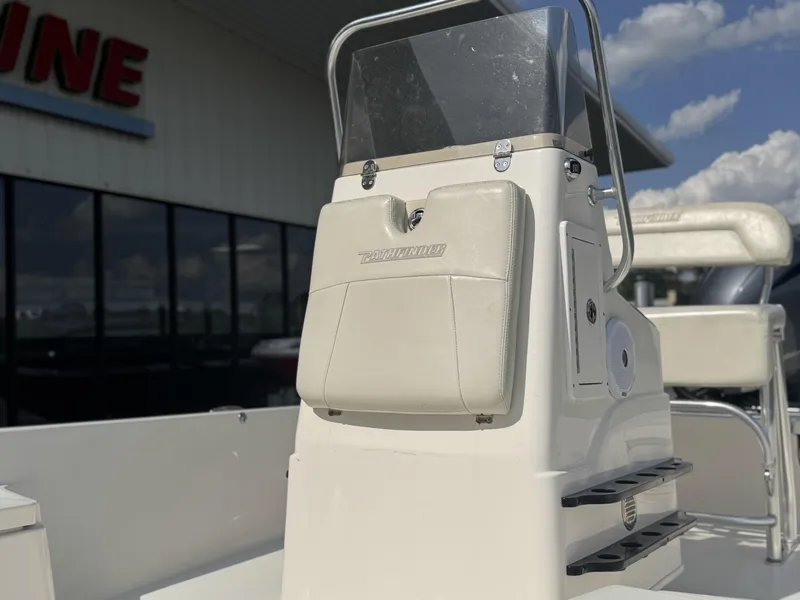 Slide: The Image of 2014 Pathfinder 2200 TRS boat console with windshield, outdoors under a blue sky. - 7