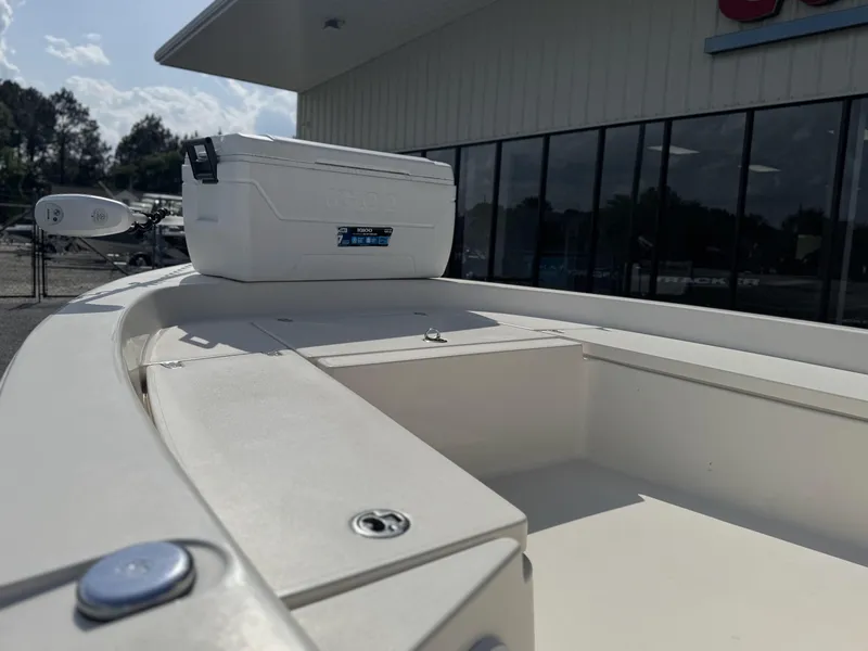 Slide: The Image of 2014 Pathfinder 2200 TRS boat deck with cooler, parked outside a building. - 8