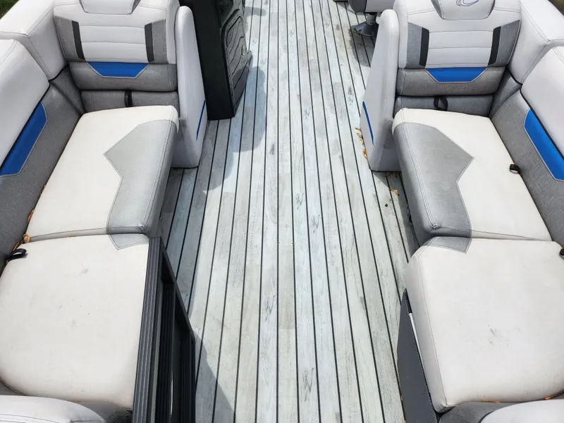 Slide: The Image of 2017 Crest Caliber 230 SLC boat interior with gray and blue seating. - 10