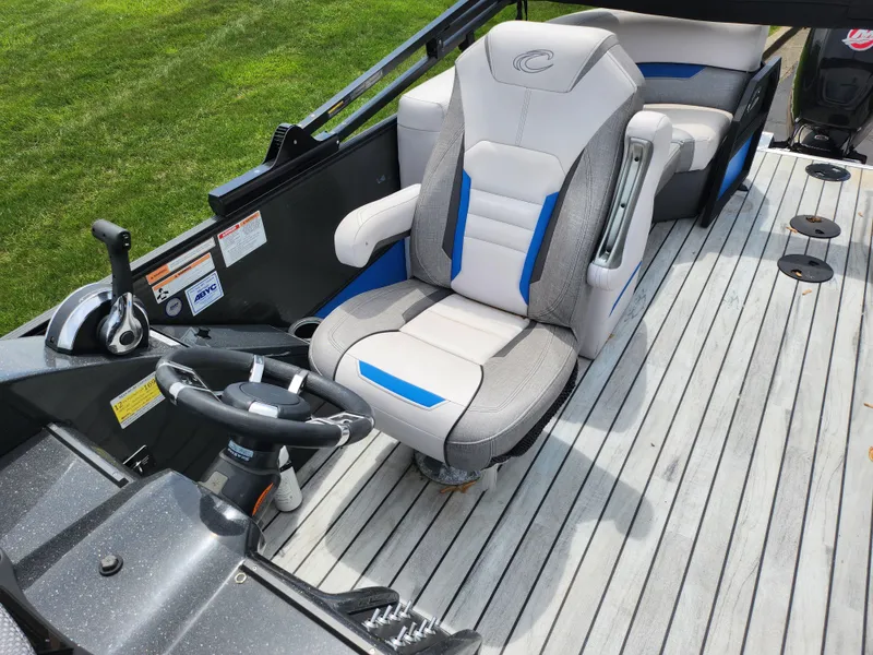 Slide: The Image of 2017 Crest Caliber 230 SLC boat interior with captain's chair and steering wheel. - 13