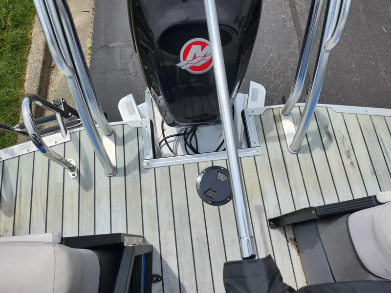 Slide: The Image of 2017 Crest Caliber 230 SLC boat deck with motor and seating area. - 16