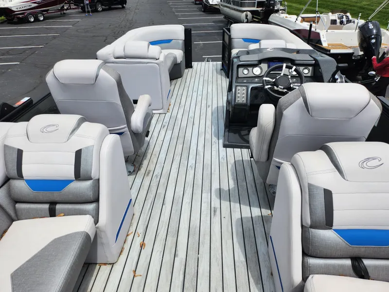 Slide: The Image of 2017 Crest Caliber 230 SLC boat interior with plush seating and modern dashboard. - 17