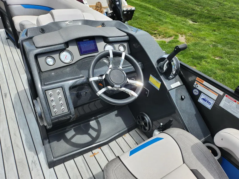 Slide: The Image of 2017 Crest Caliber 230 SLC boat dashboard with steering wheel and controls. - 18