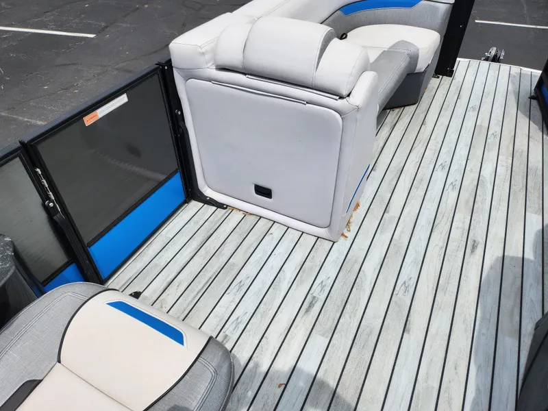 Slide: The Image of 2017 Crest Caliber 230 SLC boat interior with gray seating and striped flooring. - 19