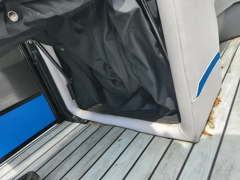 Slide: The Image of 2017 Crest Caliber 230 SLC boat interior with gray seating and black storage compartment. - 20