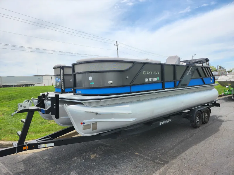 Slide: The Image of 2017 Crest Caliber 230 SLC pontoon boat on trailer, parked outdoors. - 5