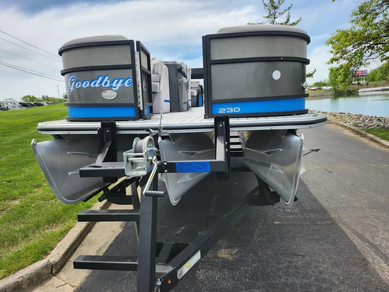 Slide: The Image of 2017 Crest Caliber 230 SLC pontoon boat on trailer, parked near a lake. - 6