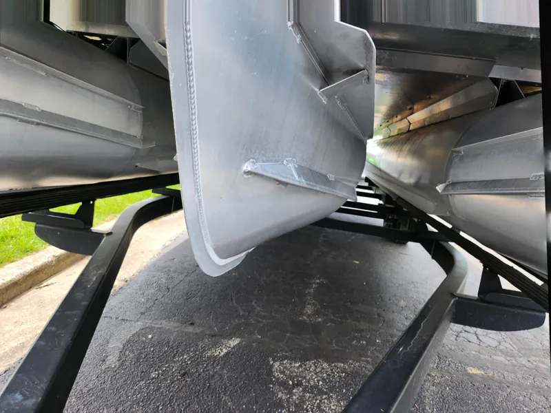 Slide: The Image of Underneath view of a 2017 Crest Caliber 230 SLC pontoon boat on a trailer. - 7