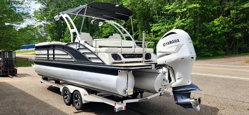 Slide: The Image of 2020 Bennington R 25 RSBA pontoon boat with Yamaha engine on trailer, parked roadside. - 4