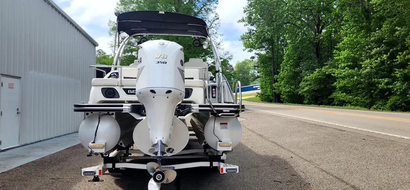 Slide: The Image of 2020 Bennington R 25 RSBA pontoon boat parked on a road near trees. - 5