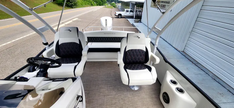 Slide: The Image of 2020 Bennington R 25 RSBA boat interior with plush seating and steering console. - 9