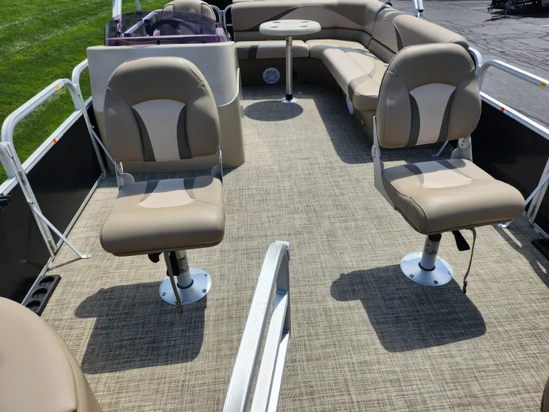 Slide: The Image of 2016 SunCatcher V20 Fish & Cruise pontoon boat interior with beige seating and carpet. - 10