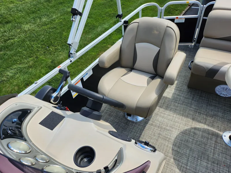 Slide: The Image of 2016 SunCatcher V20 Fish & Cruise boat interior with beige captain's chair and control panel. - 12