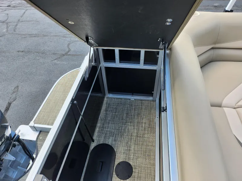 Slide: The Image of 2016 SunCatcher V20 Fish & Cruise boat interior storage compartment with beige seating. - 16