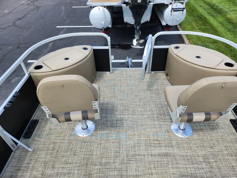 Slide: The Image of 2016 SunCatcher V20 Fish & Cruise boat interior with beige seating and carpeted floor. - 23