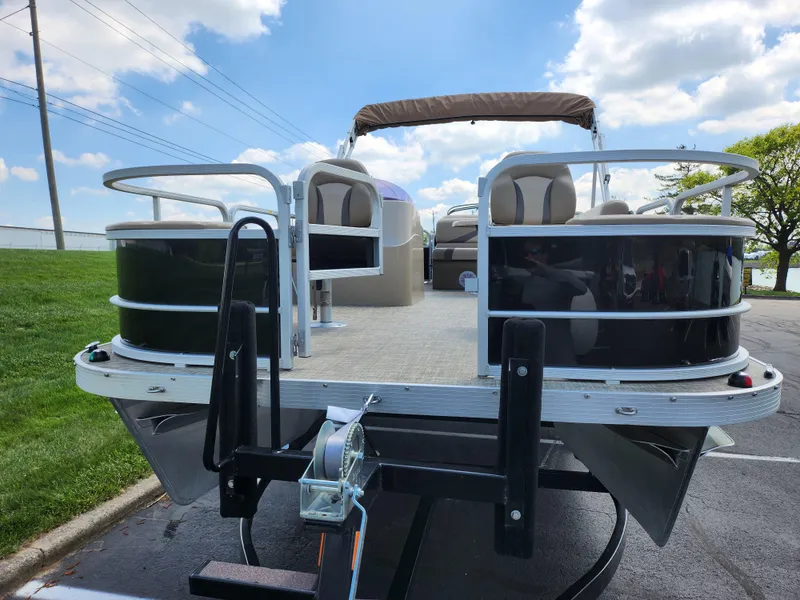 Slide: The Image of 2016 SunCatcher V20 Fish & Cruise pontoon boat on trailer, under blue sky. - 6