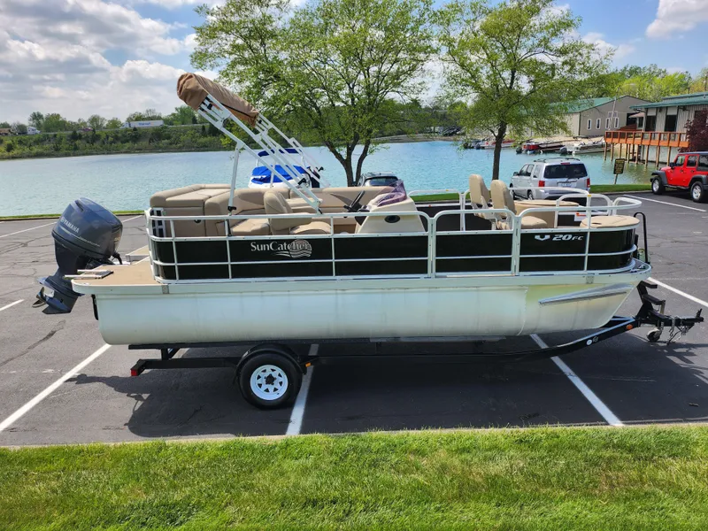 Slide: The Image of 2016 SunCatcher V20 Fish & Cruise pontoon boat on trailer by a lake. - 9