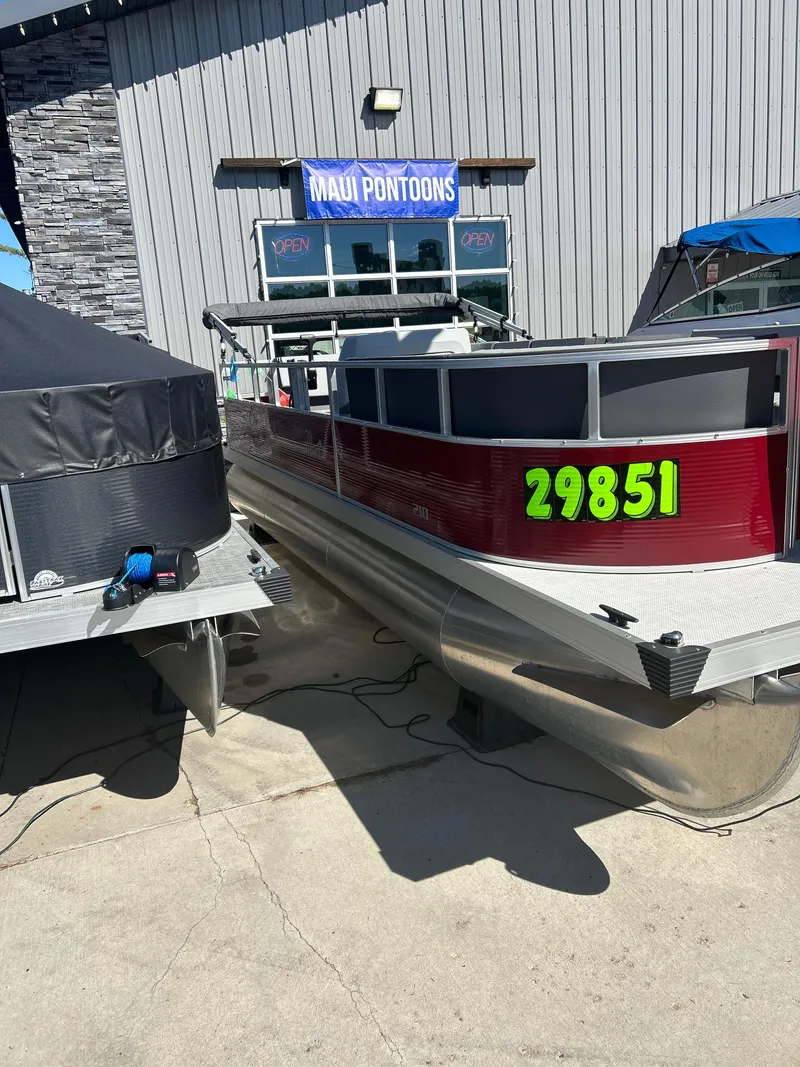 Slide: The Image of 2025 Custom Maui 210 Cruise pontoon boat displayed at Maui Pontoons dealership. - 1