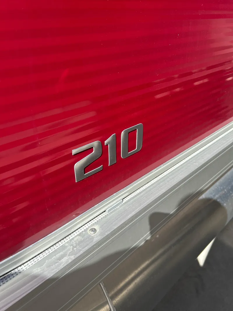 Slide: The Image of Red Custom Maui 210 Cruise boat, 2025 model, with metallic "210" emblem. - 4