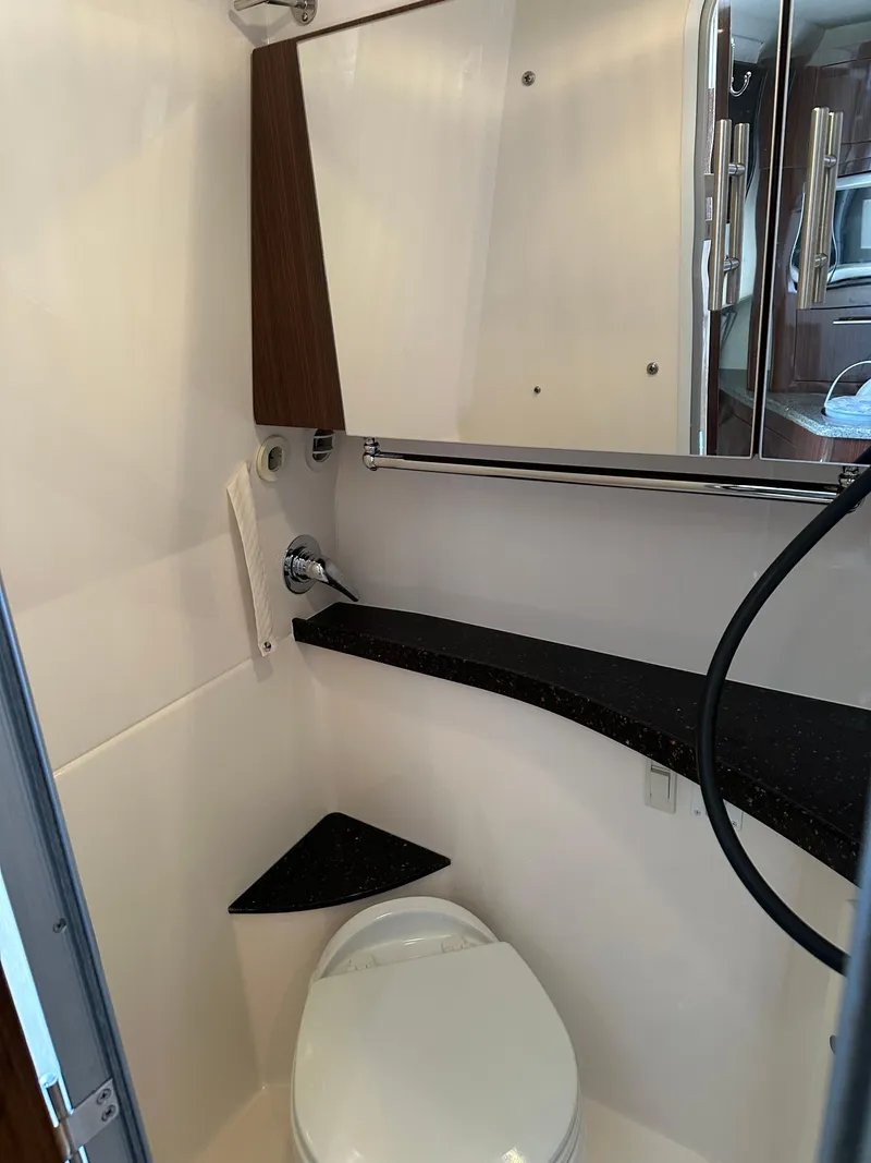 Slide: The Image of 2014 Regal 28 Express boat bathroom with modern fixtures and compact design. - 5