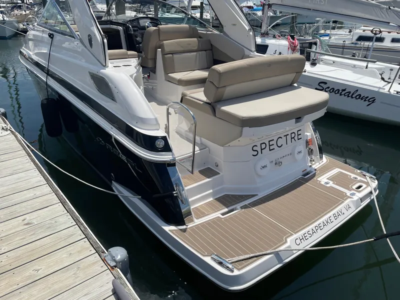 Slide: The Image of 2014 Regal 28 Express boat docked, featuring spacious seating and sleek design. - 7