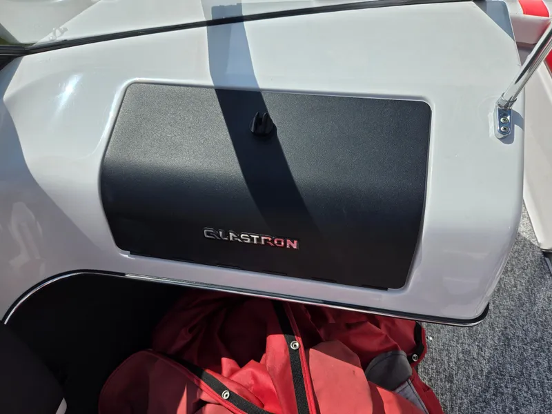 Slide: The Image of 2014 Glastron GT 185 boat dashboard with storage compartment and red bag. - 15