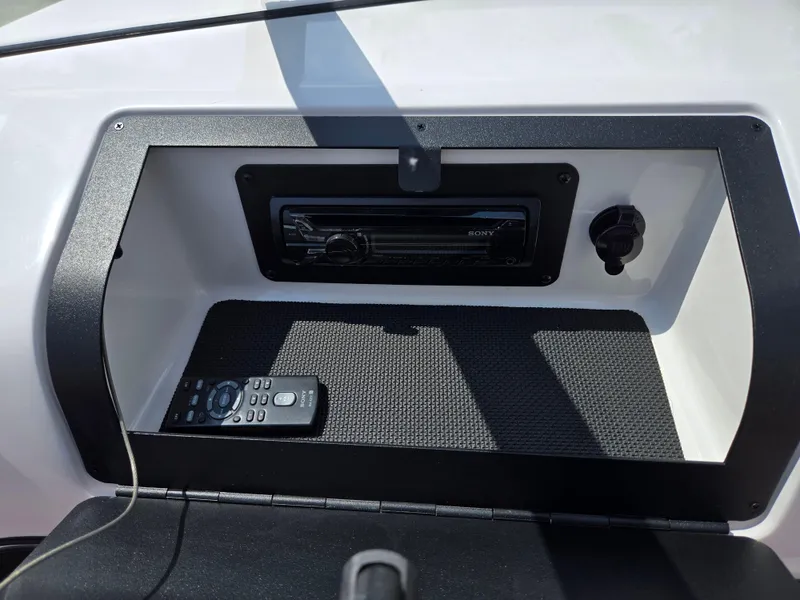 Slide: The Image of 2014 Glastron GT 185 boat dashboard with Sony stereo and remote control. - 16