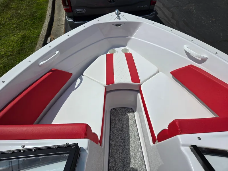 Slide: The Image of 2014 Glastron GT 185 boat interior with red and white seating, featuring cup holders. - 17