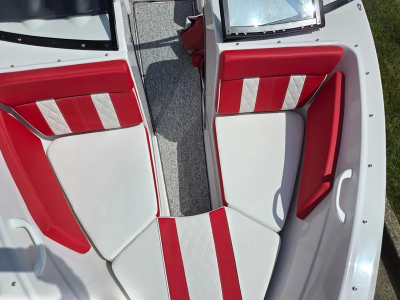 Slide: The Image of 2014 Glastron GT 185 boat interior with red and white seating, viewed from above. - 18