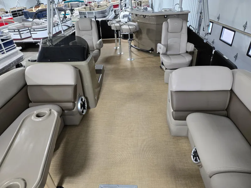Slide: The Image of 2013 Premier 290 Grand Entertainer pontoon boat interior with seating and bar area. - 13