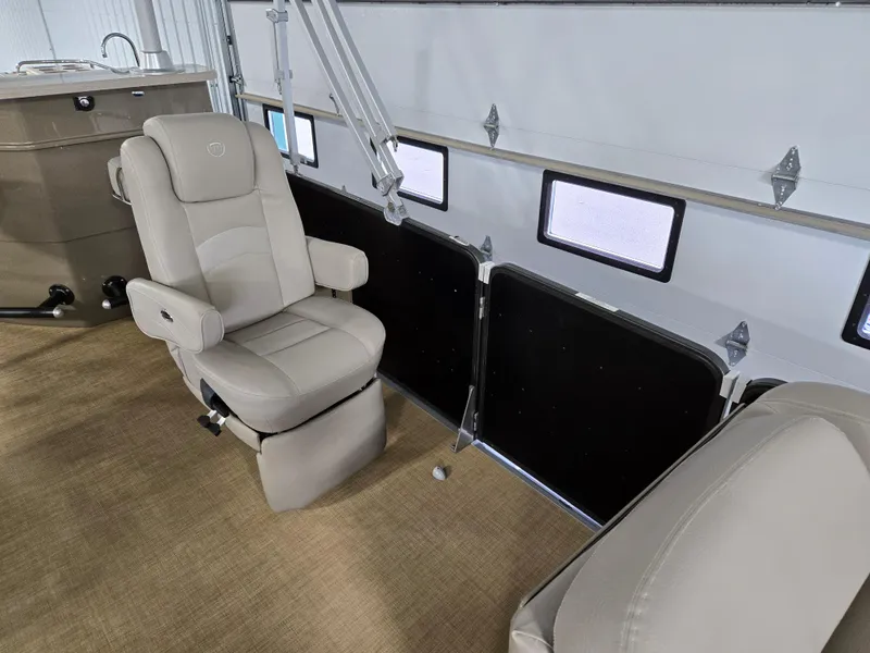 Slide: The Image of 2013 Premier 290 Grand Entertainer boat interior with beige seating and carpeted flooring. - 14
