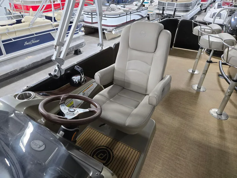 Slide: The Image of 2013 Premier 290 Grand Entertainer boat interior with captain's chair and steering wheel. - 15