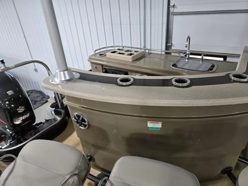 Slide: The Image of 2013 Premier 290 Grand Entertainer boat interior with bar and sink setup. - 17