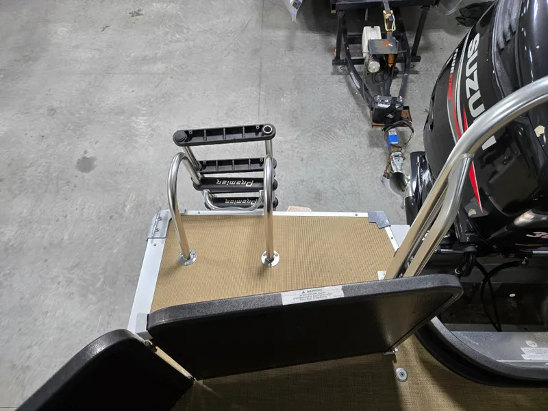 Slide: The Image of 2013 Premier 290 Grand Entertainer boat with ladder and Suzuki engine in a garage setting. - 19