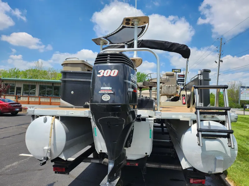 Slide: The Image of 2013 Premier 290 Grand Entertainer pontoon boat with 300 horsepower engine, docked outdoors. - 2