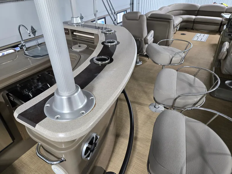 Slide: The Image of 2013 Premier 290 Grand Entertainer boat interior with bar and seating area. - 23